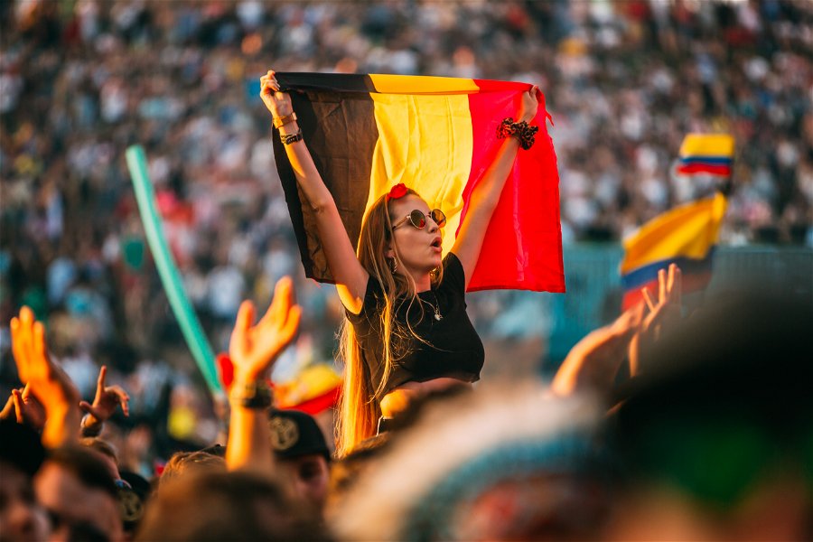 Girl waving Belgian flag at Tomorrowland