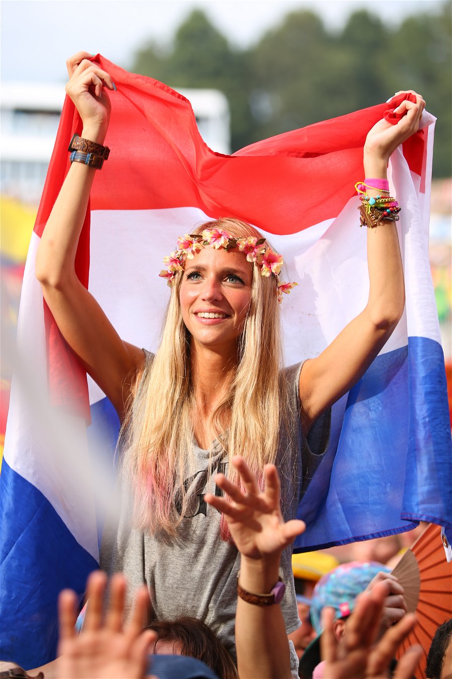 Girl waving Dutch flag at Tomorrowland